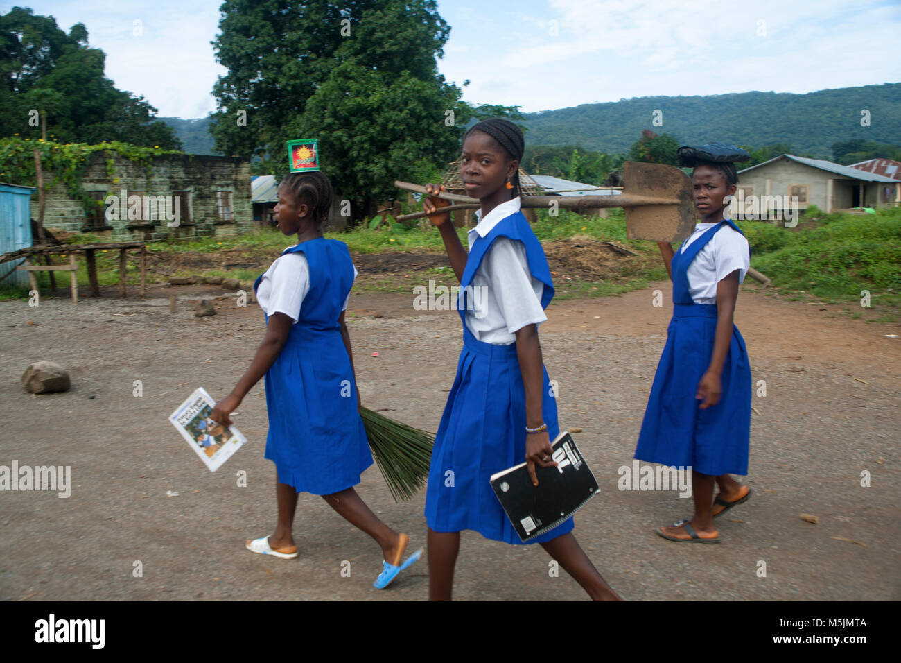 African girls walking to school wearing uniforms Stock Photo