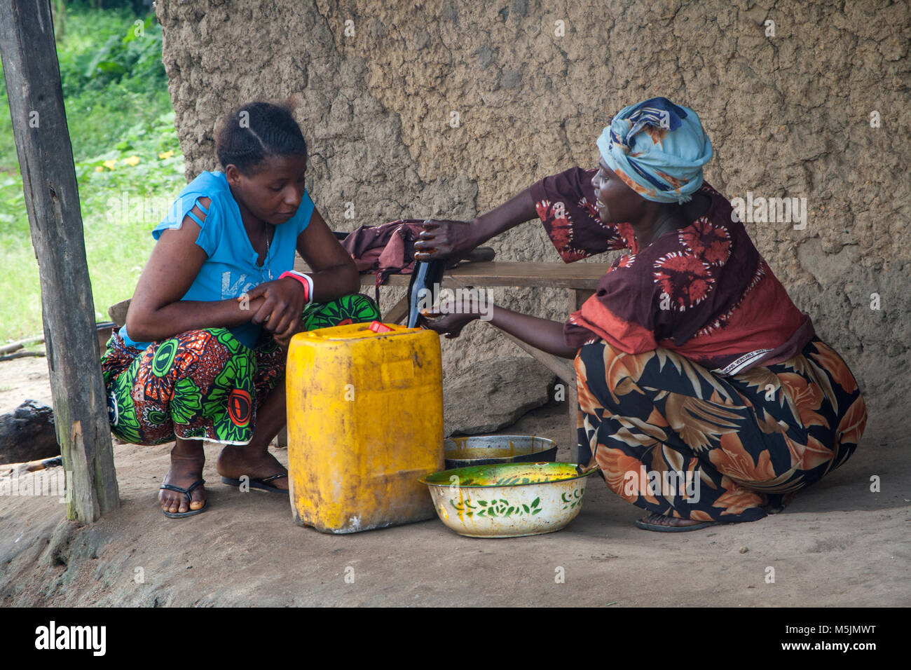 Women  sell palm oil in rural Sierra Leone Stock Photo
