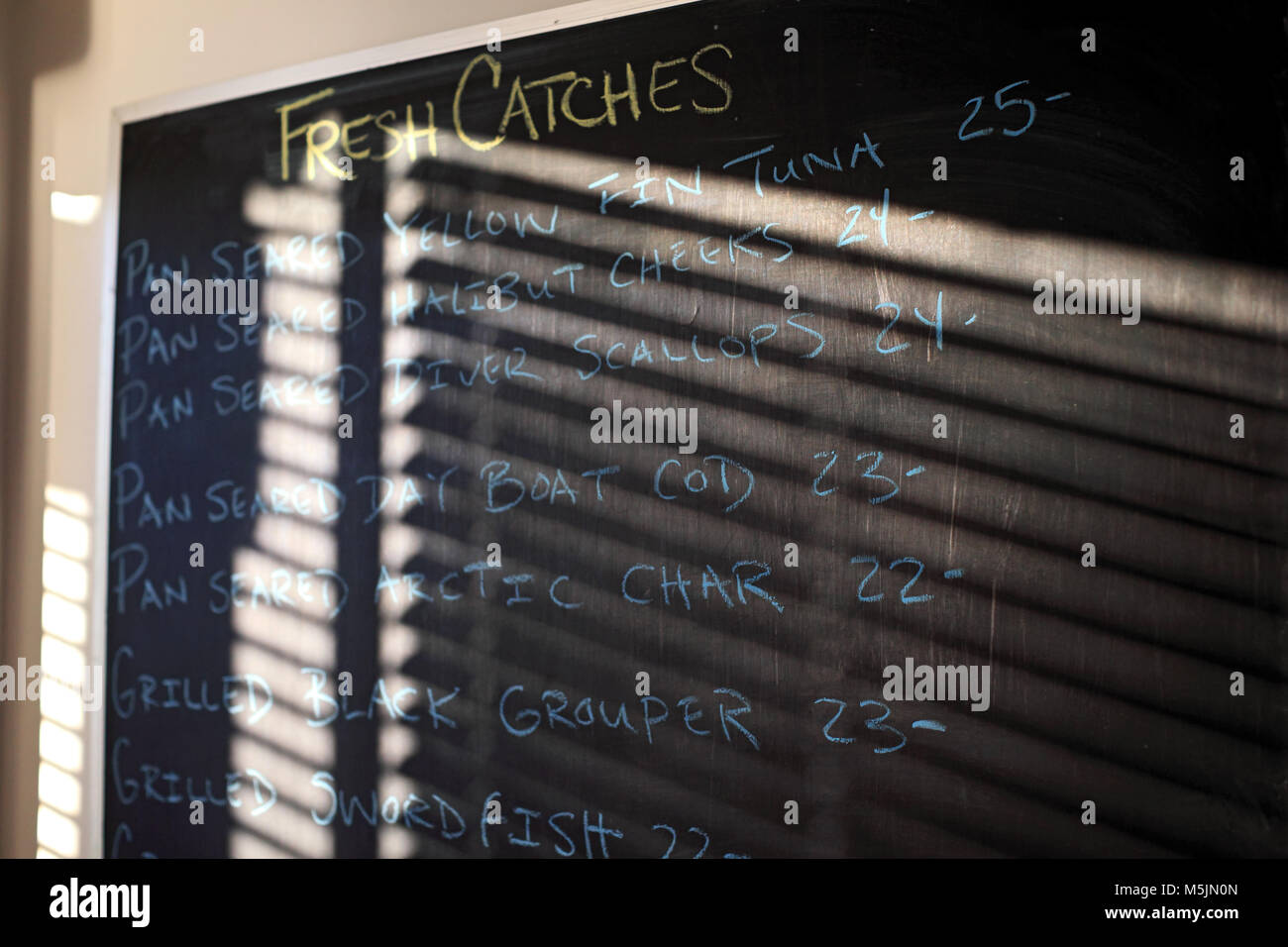 Restaurant menu written on a chalk board. Stock Photo