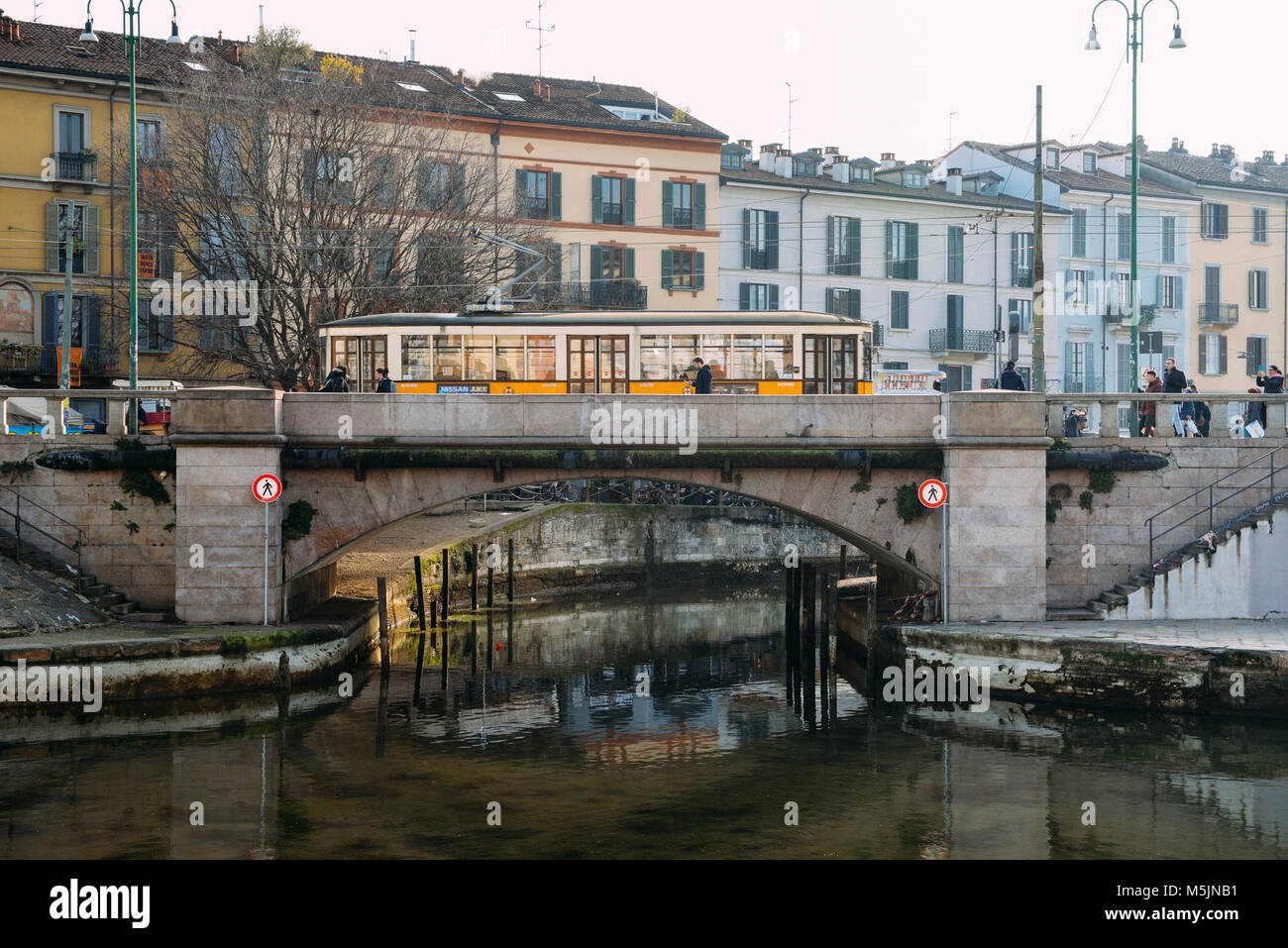 Milan, Italy - Feb 24, 2018: Traditional milanese tram on Naviglio Grande in Milan during winter Stock Photo