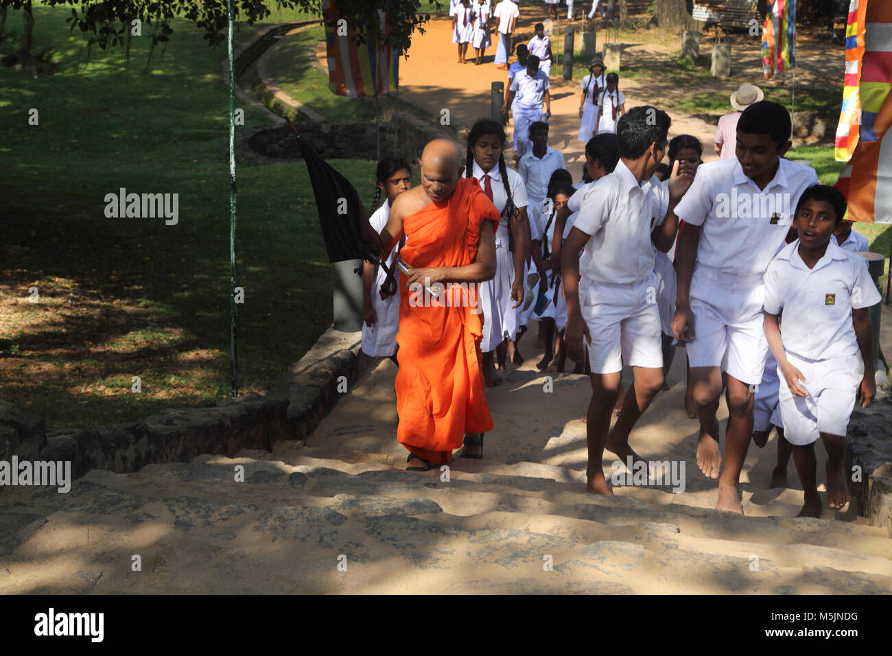 Polonnaruwa North Central Province Sri Lanka School Children And Monk Climbing Stairs to See ruins Stock Photo
