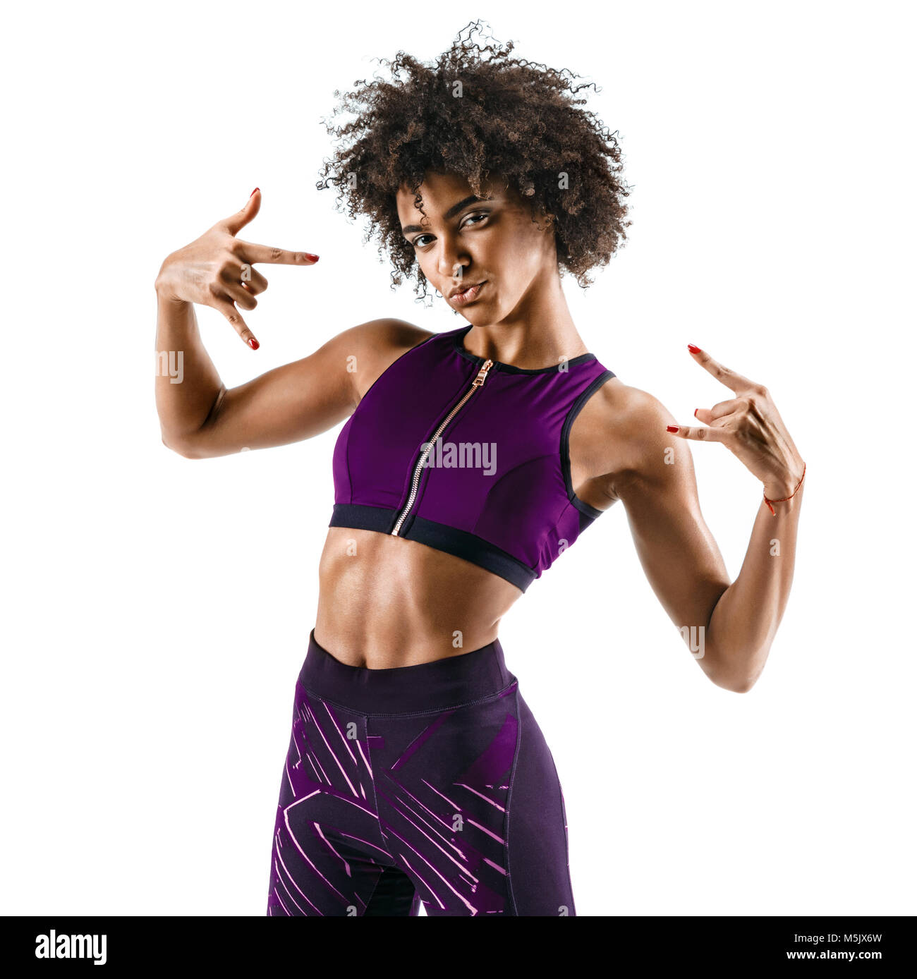 Sporty girl  showing gesturing with fingers rock and roll. Photo of cool funny african girl isolated on white background. Strength and motivation Stock Photo