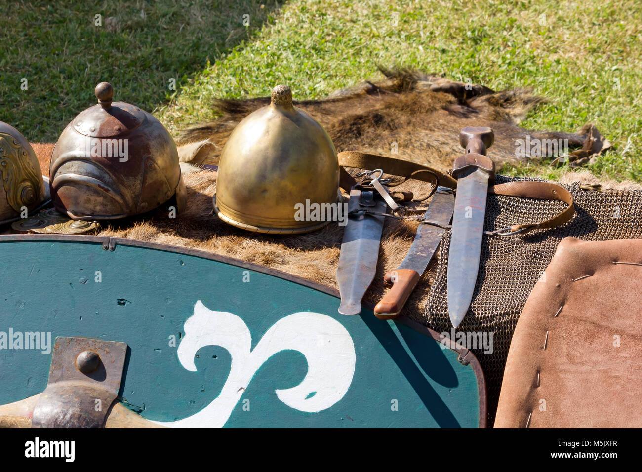 Ancient gallic helmets, shield and daggers at a historical reenactment Stock Photo