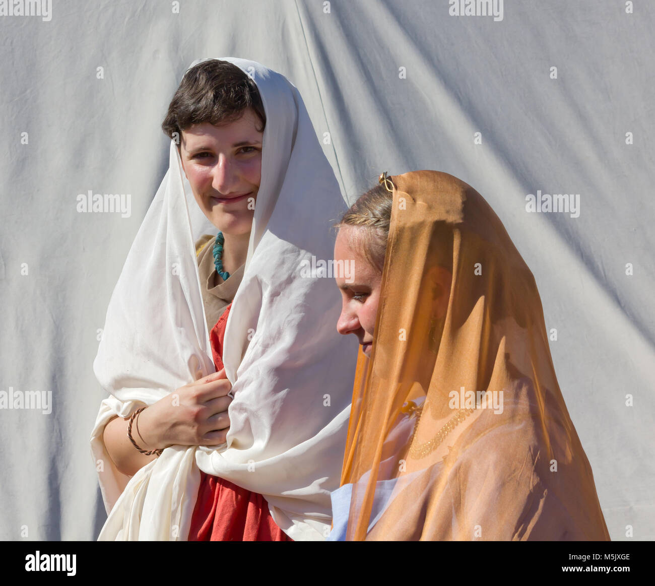 AQUILEIA, Italy - June 18, 2017 : Close-up on two young girls wearing stage costume at the annual local ancient Roman historical reenactment Stock Photo
