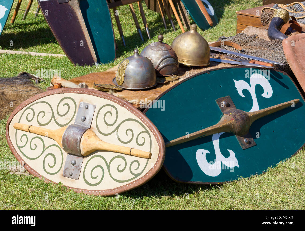 Ancient Gallic battle equipment including shields, helmets, swords and daggers Stock Photo