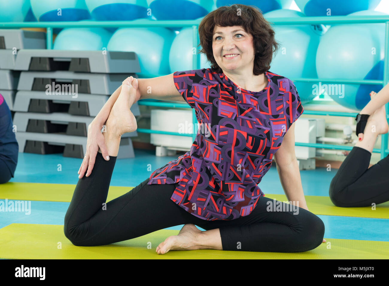 Woman doing yoga exercise in the gym Stock Photo