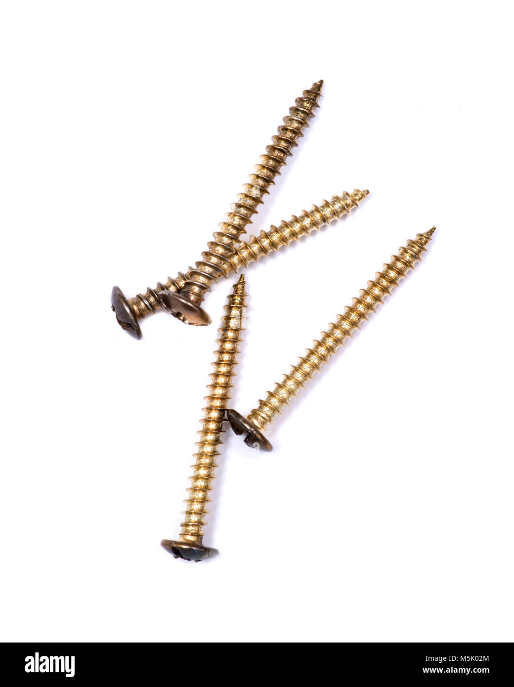 Large brass decorative screws isolated on white background Stock Photo