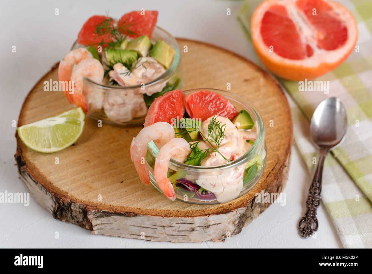 Cocktail salad with shrimp, avocado, green lettuce, grapefruit and