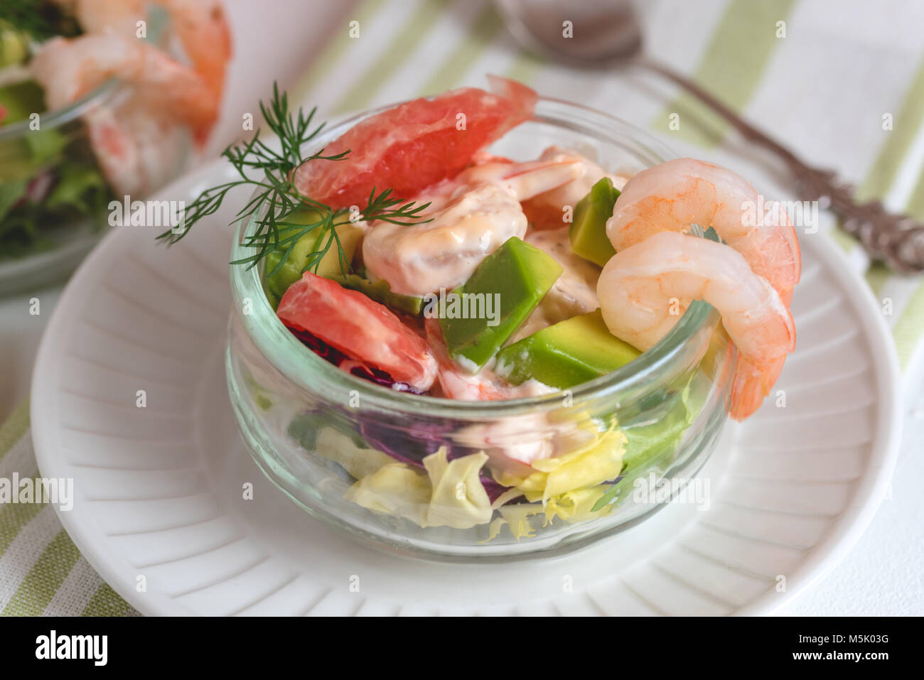 Cocktail salad with shrimp, avocado, green lettuce, grapefruit and