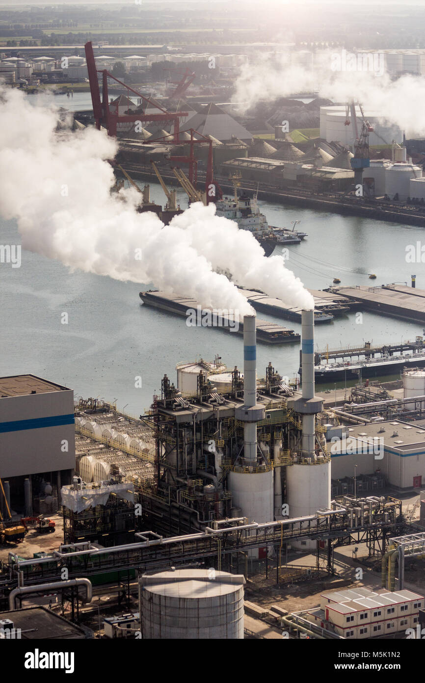 Air pollution from chimney exhaust at a petrochemical plant in a large industrial port. Stock Photo