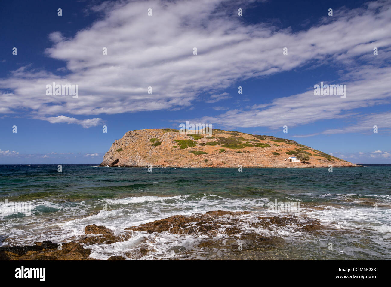 Rocky shoreline and island at Mochlos on the Mediterranean island of Crete Stock Photo