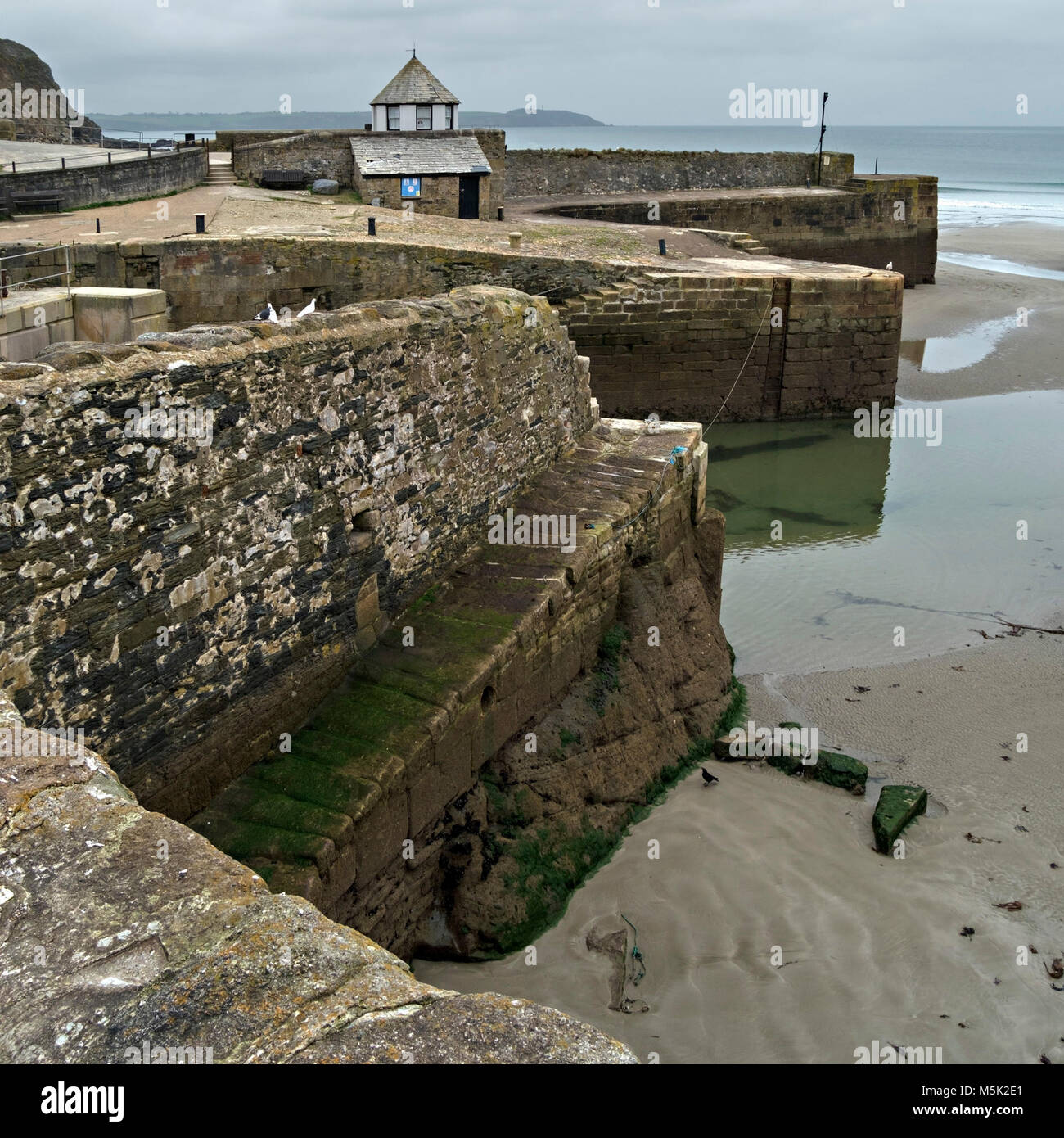 Old coastal sea defences and granite harbour walls, Charlestown Harbour, Cornwall, England, UK Stock Photo