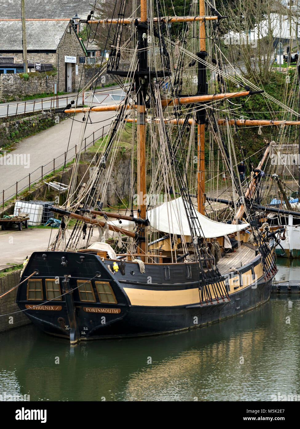 The Phoenix tall ship, wooden sailing ship moored in Charlestown Harbour, Cornwall, England. Charlestown was used as a location for filming Poldark. Stock Photo