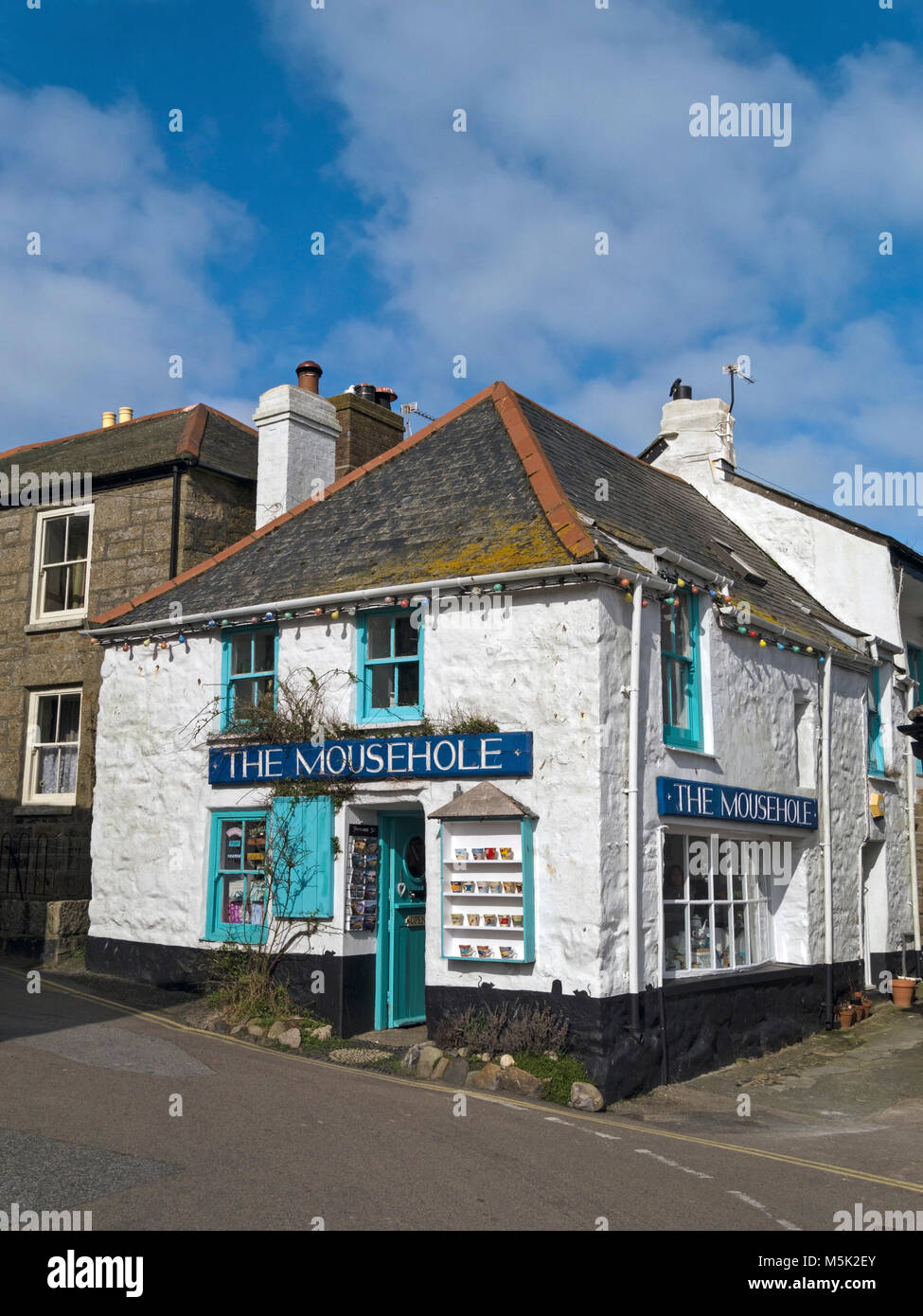 Old whitewashed seaside corner gift shop Mousehole, Cornwall, England, UK Stock Photo