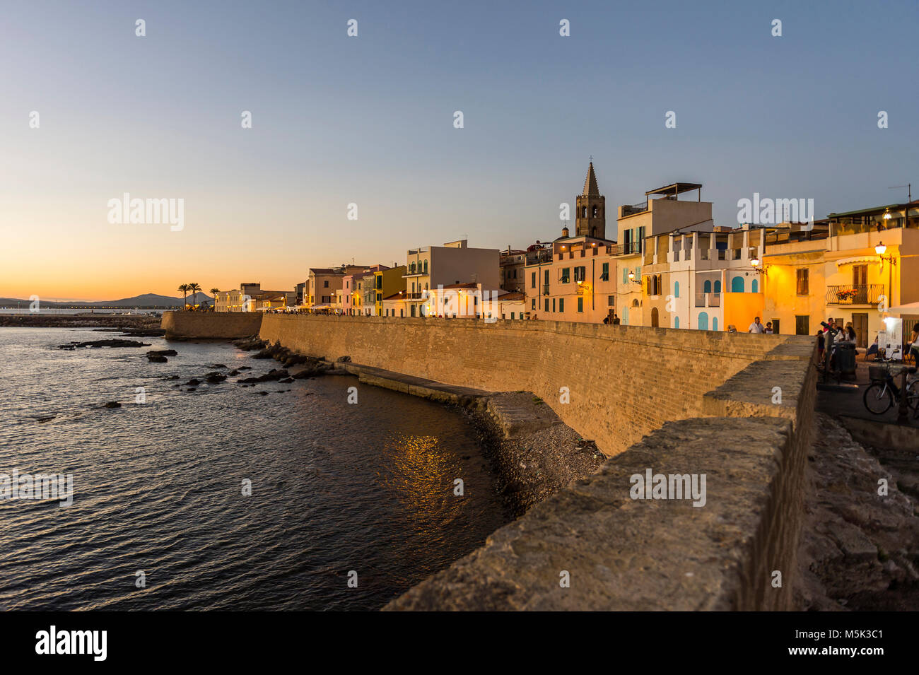 Waterfront in the coastal town of Alghero after sunset, Sardinia, Italy Stock Photo