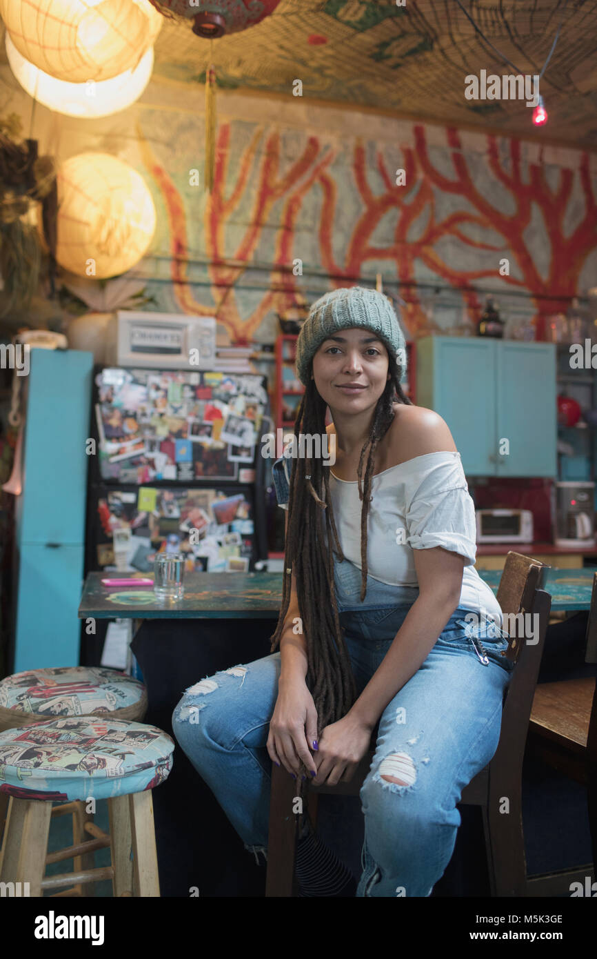 Young woman sitting in kitchen Stock Photo