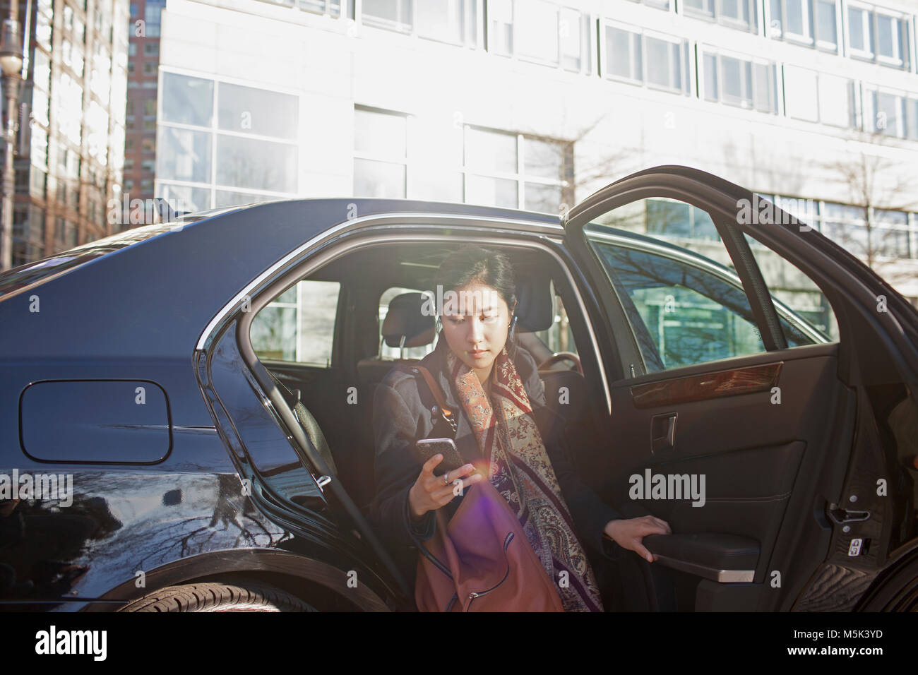 Young asian business woman getting out of car service limousine Stock Photo