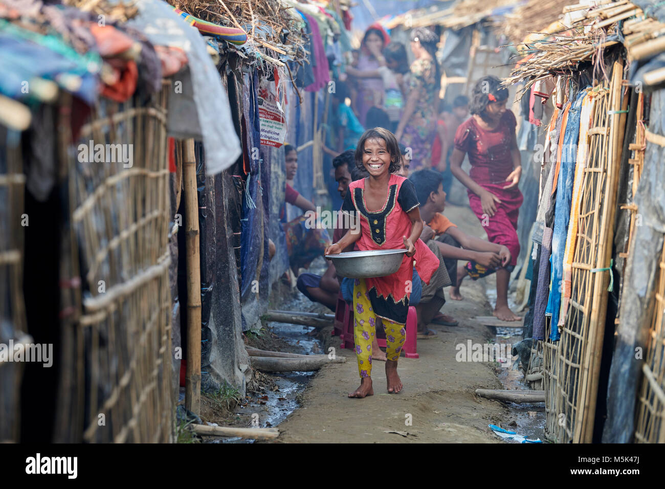A Rohingya girl walks between makeshift shelters in the Jamtoli Refugee Camp near Cox's Bazar, Bangladesh. Stock Photo