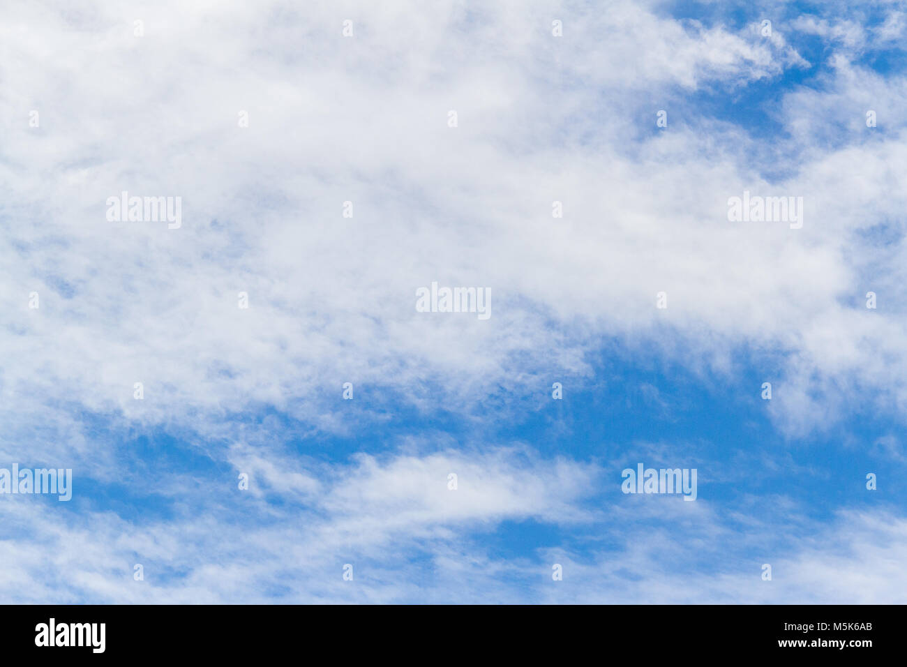 Blue sky background with white fluffy clouds Stock Photo - Alamy