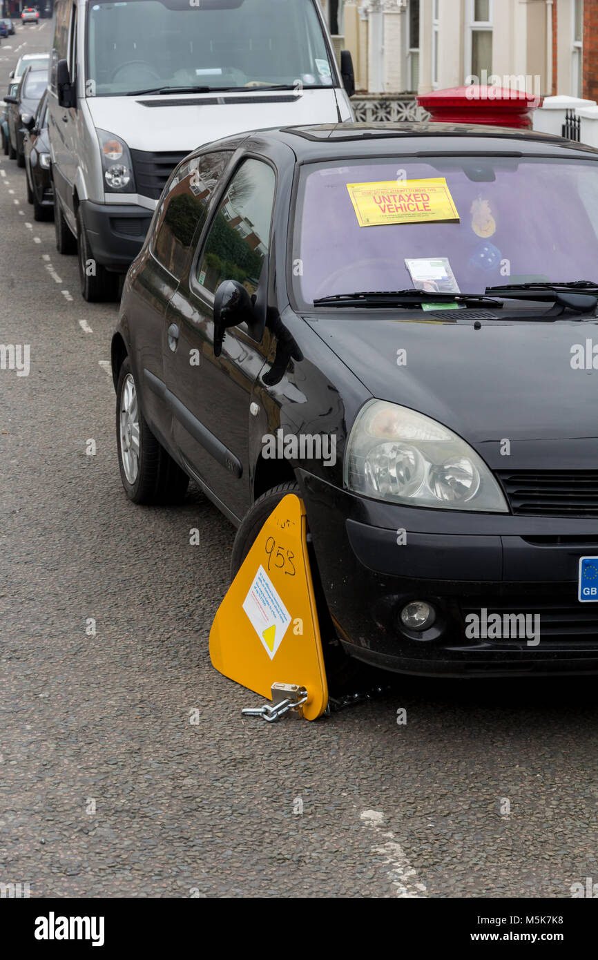 Warning sticker and clamp attached to a vehicle penalised for unpaid vehicle tax Stock Photo