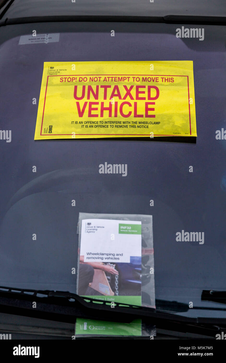 Warning sticker attached to a vehicle penalised for unpaid vehicle tax Stock Photo