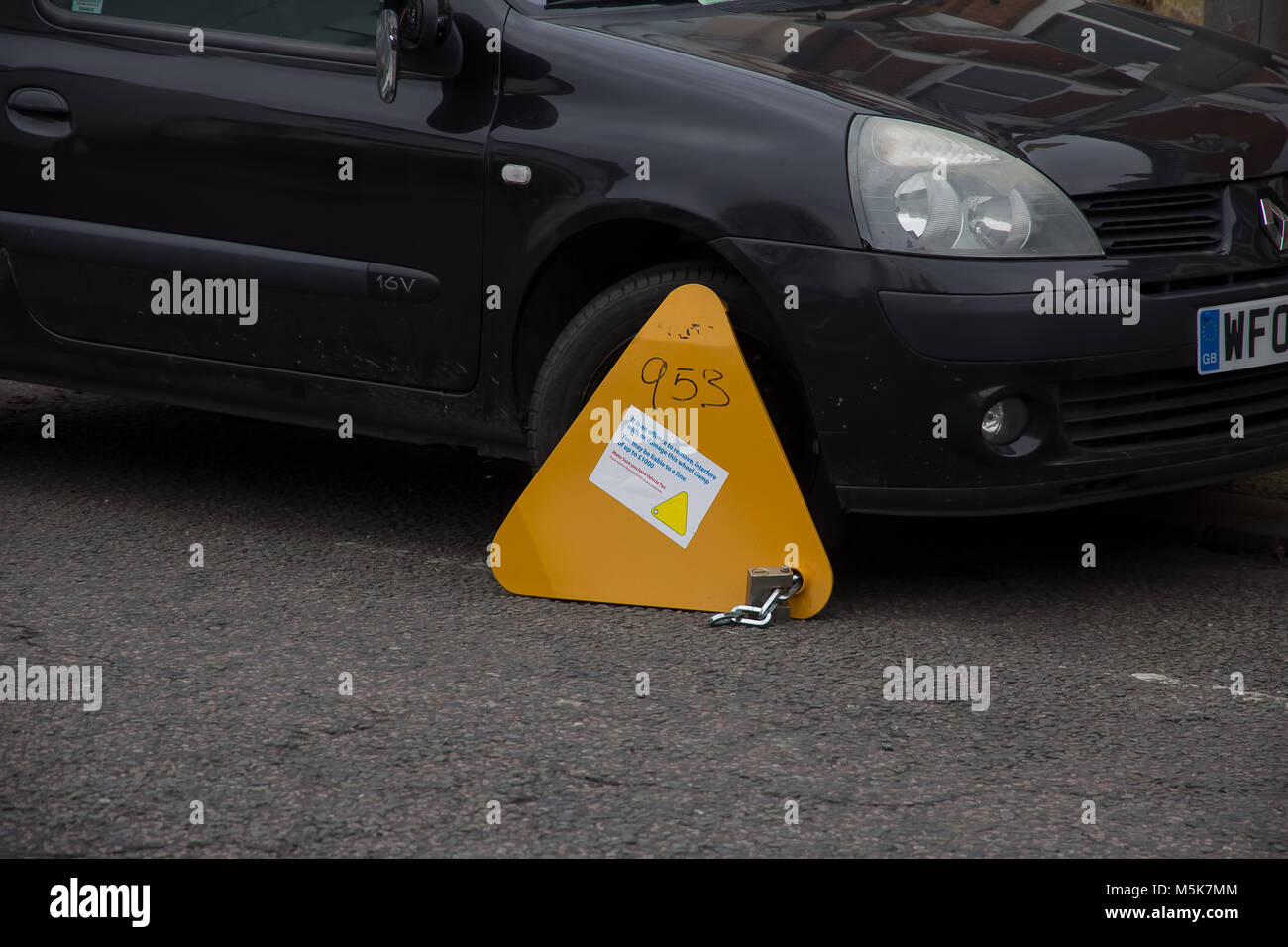 A clamp attached to a vehicle penalised for unpaid vehicle tax Stock Photo