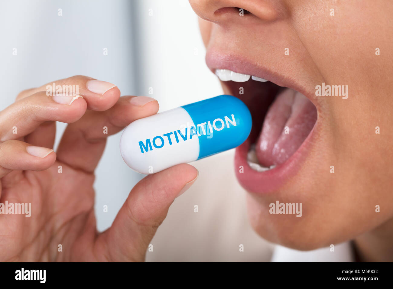 Close-up Of Photo Woman Taking Motivation Pill Stock Photo