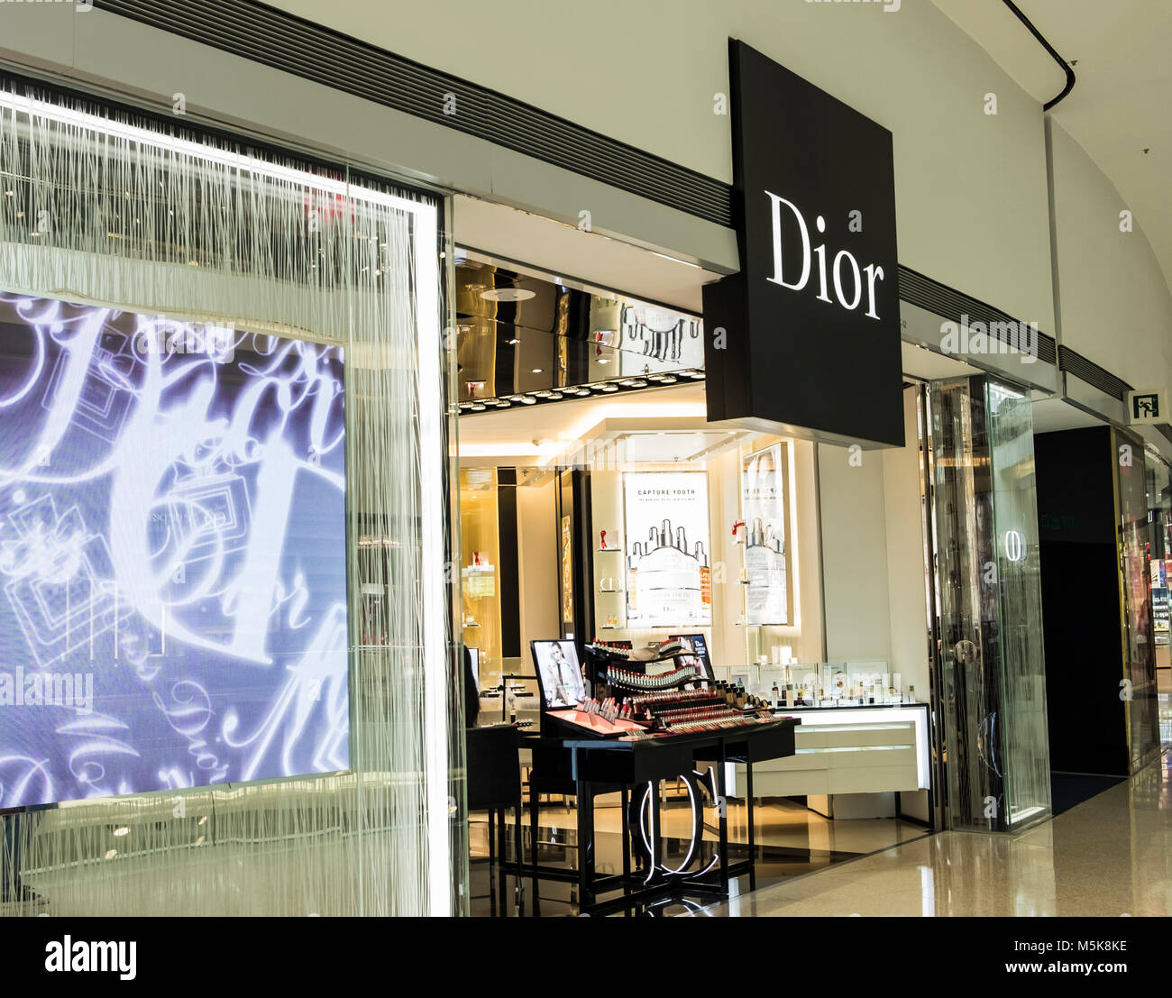 Shoppers walk past the French luxury goods, clothing and beauty brand  Christian Dior store in Hong Kong Stock Photo - Alamy