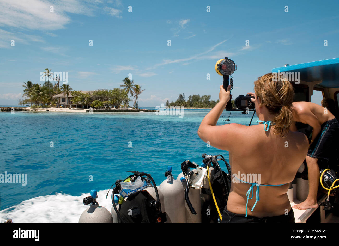 Tourist (woman) photographing a tiny island at Utila keys, Utila, Bay islands, Caribbean Stock Photo