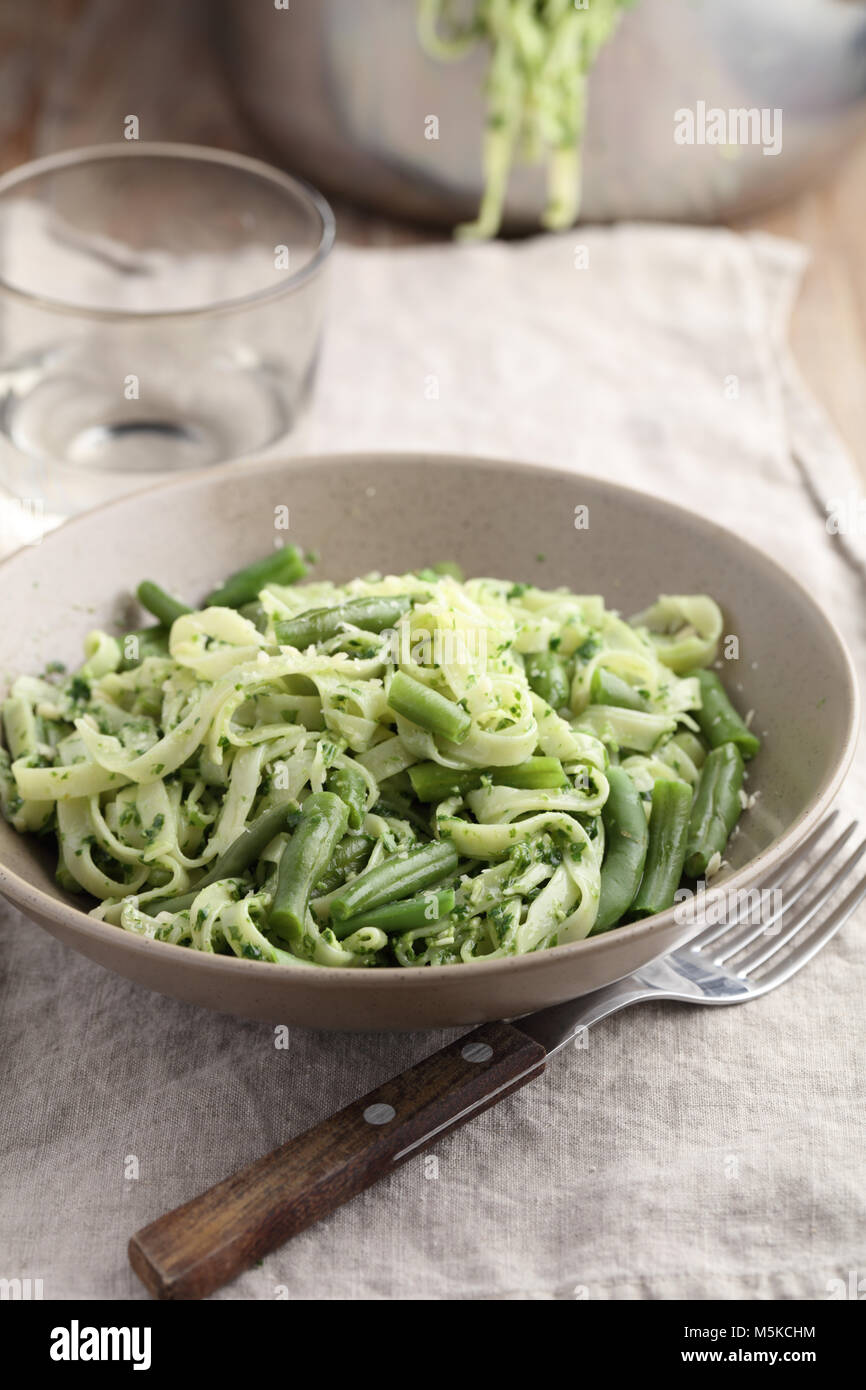 Pesto pasta with green beans on a rustic table Stock Photo Alamy