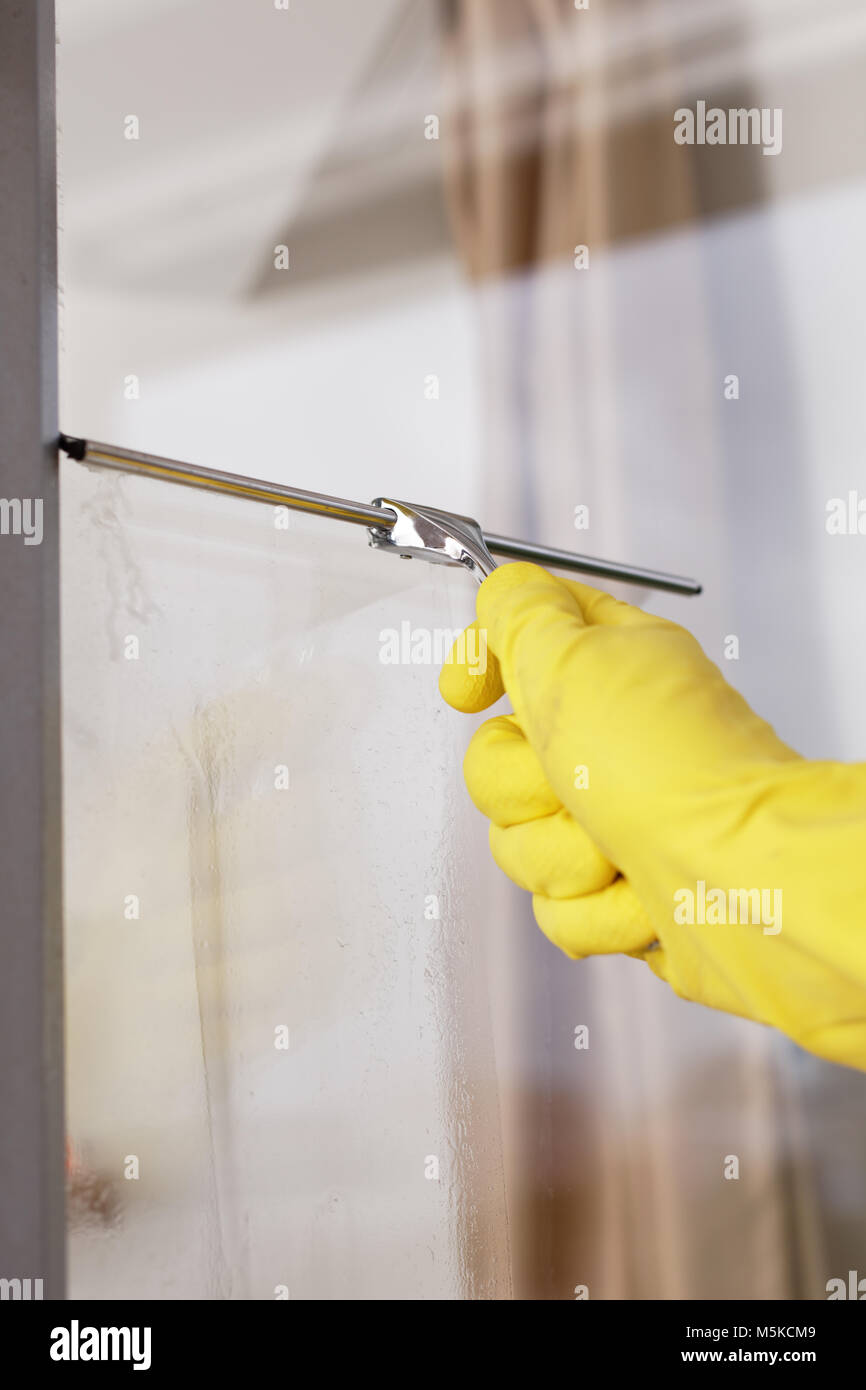 Cleaning windows using window squeegee Stock Photo Alamy