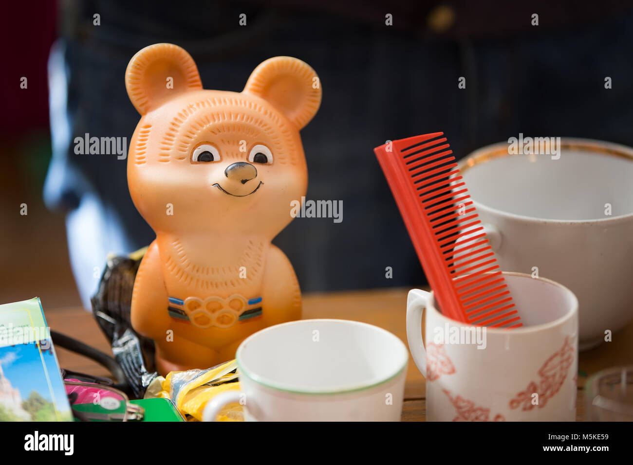 Old Olympic bear. Soviet things. Old cups and a comb. Stock Photo