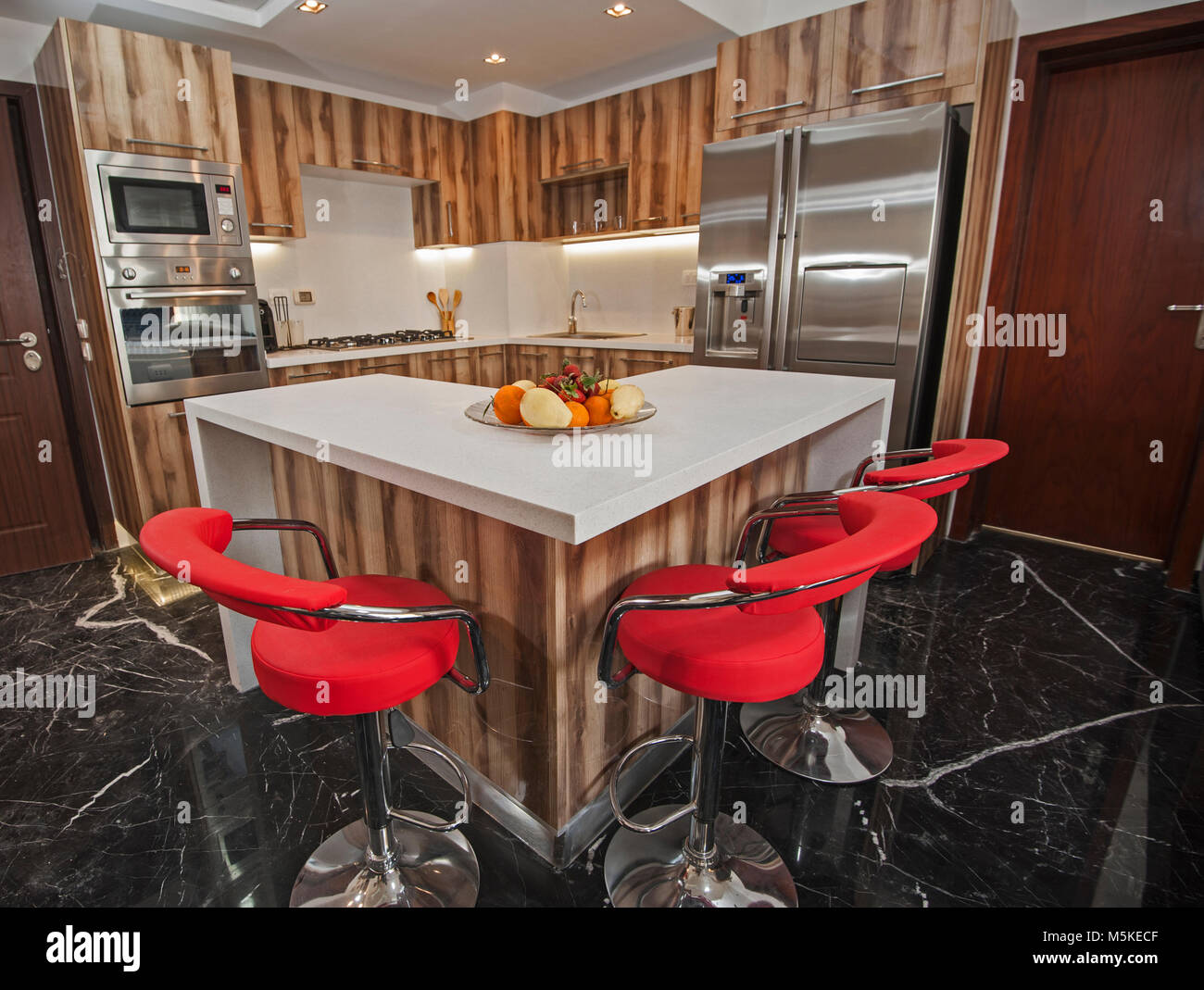 Interior design decor showing modern kitchen and appliances in luxury apartment showroom with island Stock Photo