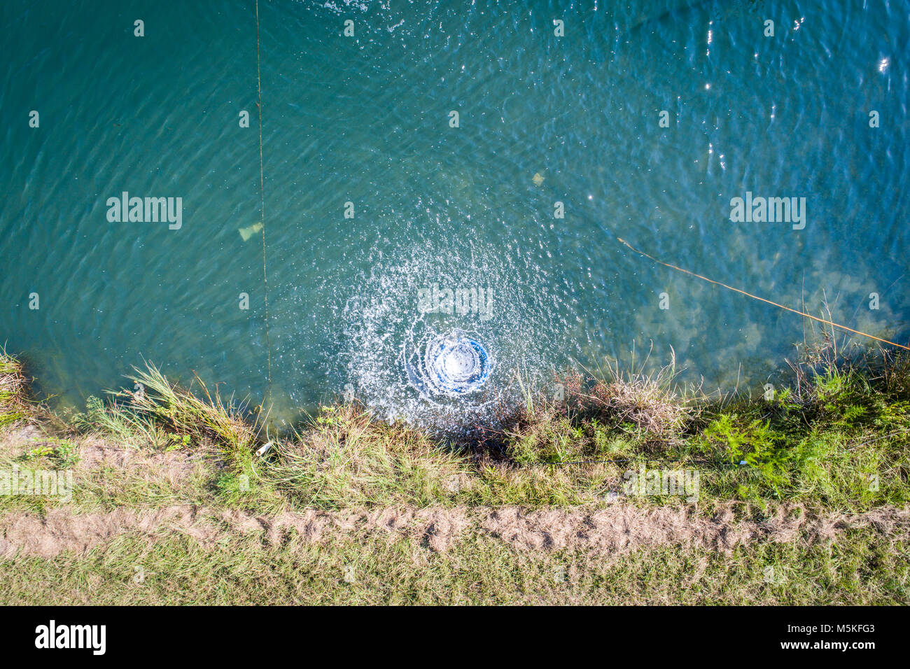 Aerator mixing water in aquaculture ponds at the University of