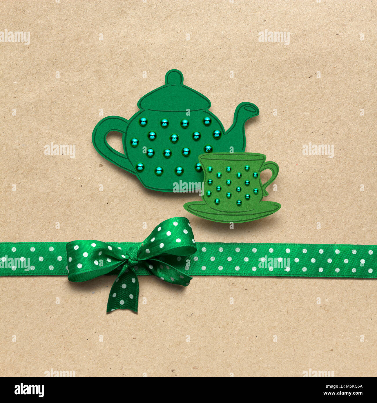 Creative concept photo of a tea set mad of paper on brown background. Stock Photo