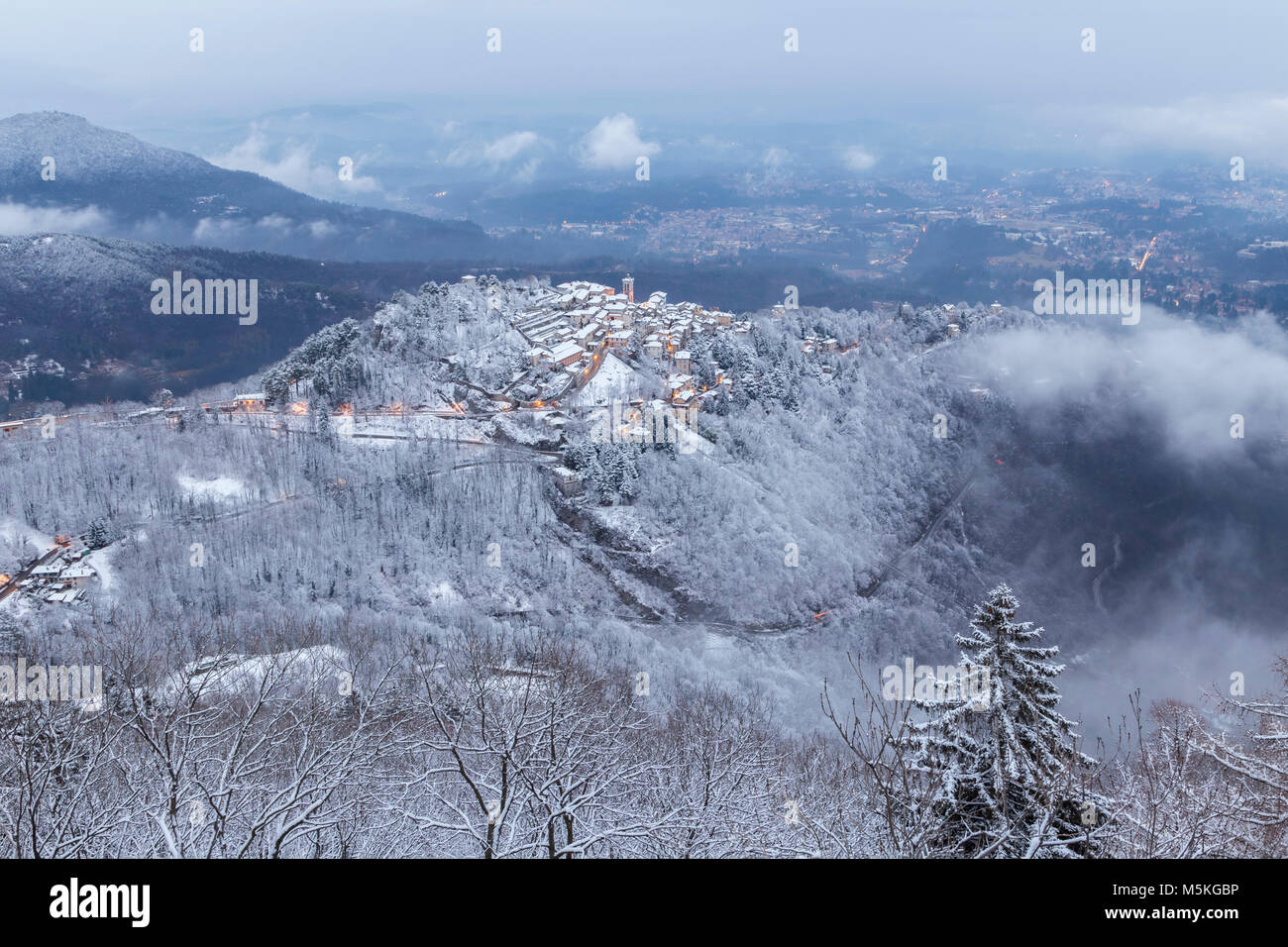 View of Santa Maria del Monte after a snowfall in winter from the Campo dei Fiori. Campo dei Fiori, Varese, Parco Campo dei Fiori, Lombardy, Italy. Stock Photo
