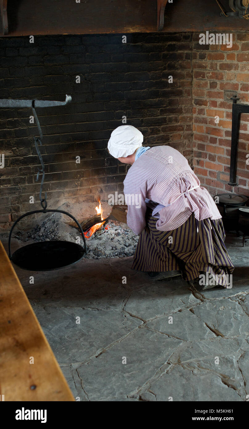 Stoking the cooking fire in the Officers Kitchen at Fort George Historic Site, Niagara-on-the-Lake, Ontario, Canada Stock Photo