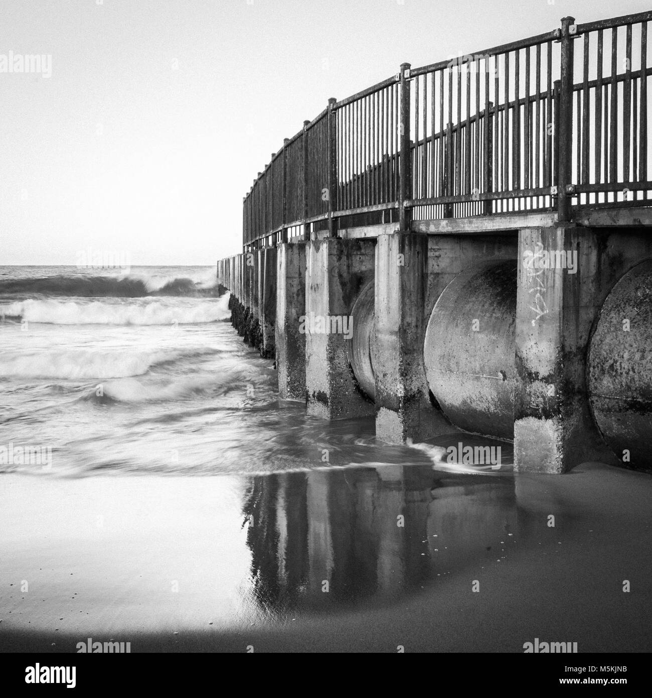 Black and White Photograph of the McGurk Beach Jetty at sunrise in Toes Beach, Playa Del Rey, CA. Stock Photo