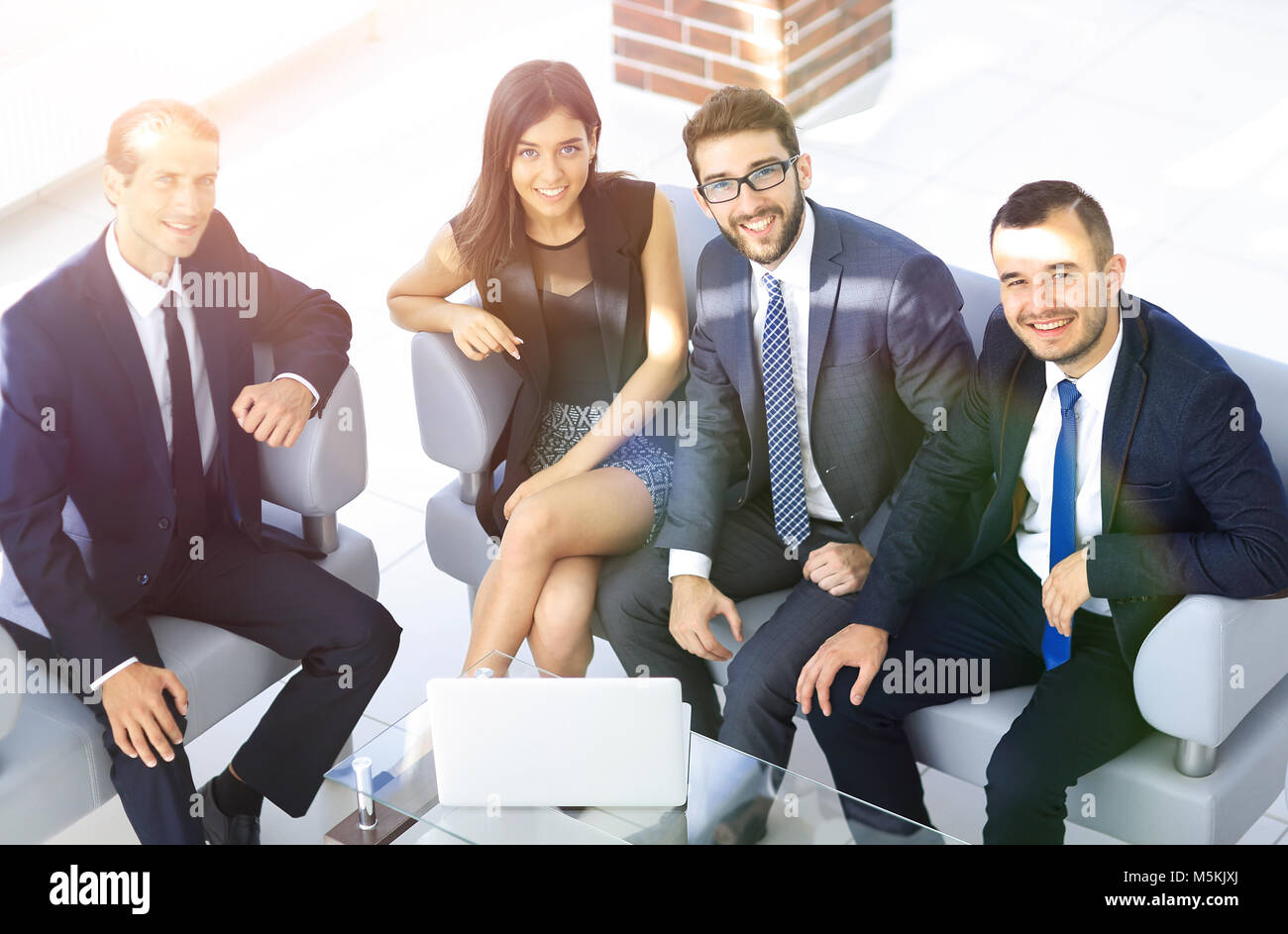 portrait of successful business team sitting in office lobby Stock ...