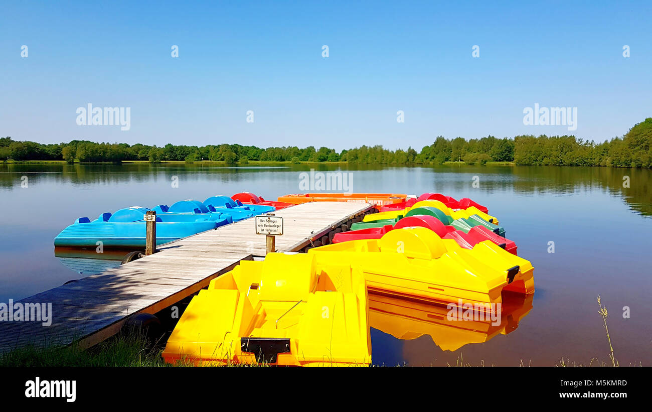 Colorful pedal boats on the boat dock at sea Stock Photo