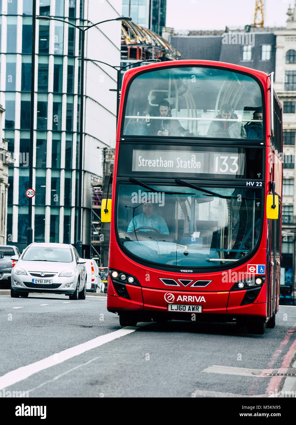 A Red London Bus travelling across London Bridge Stock Photo