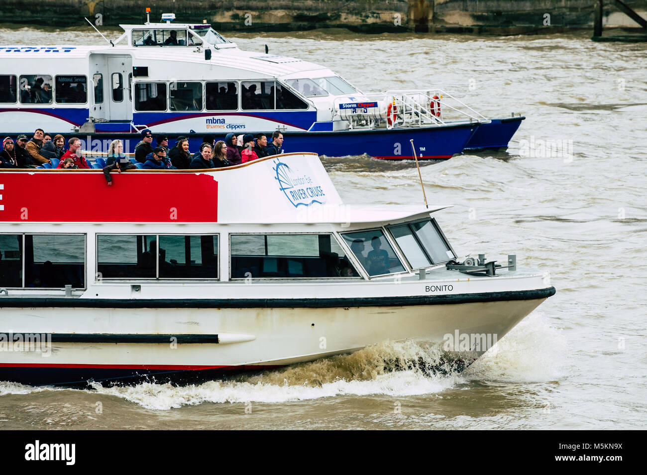 Two river boats cruis along the Thames in London Stock Photo