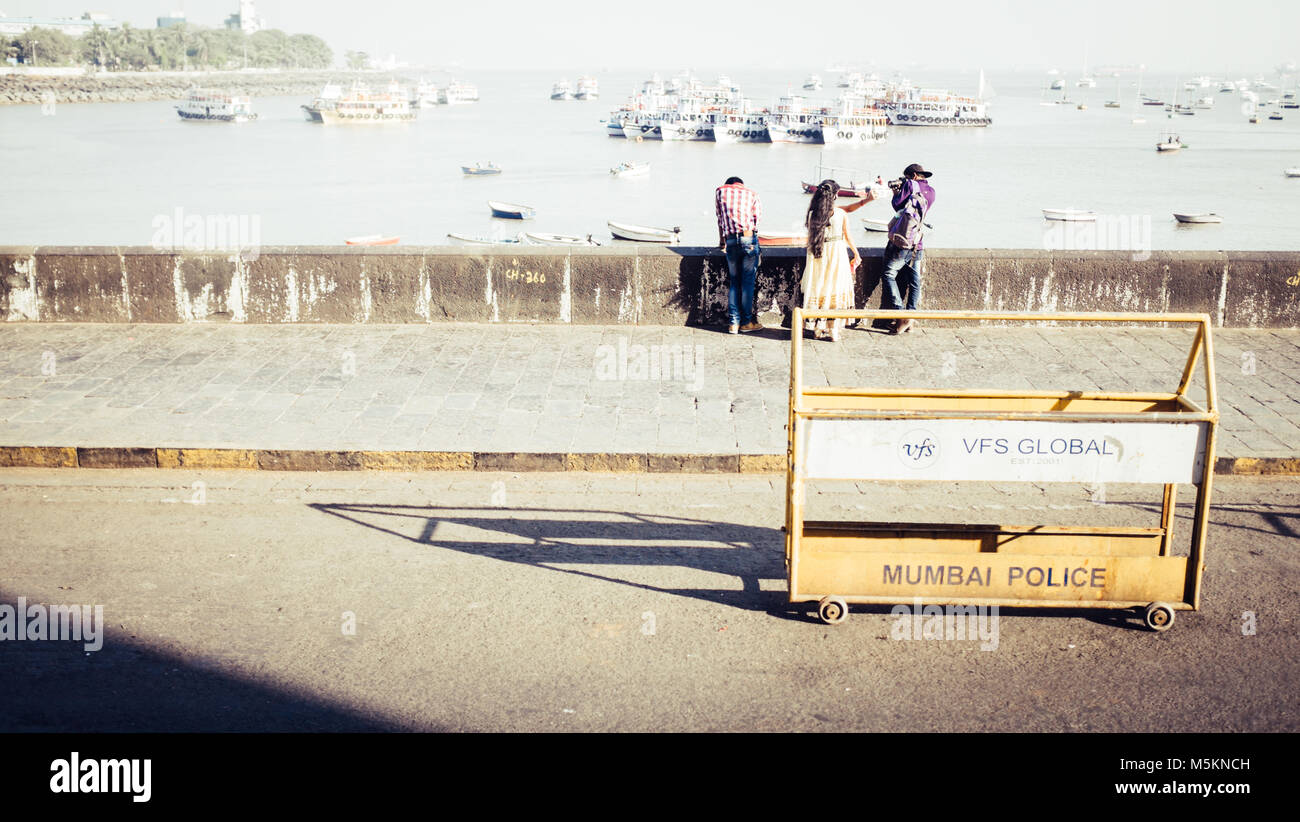 People on the sea wall at the waterfront in Mumbai, India Stock Photo