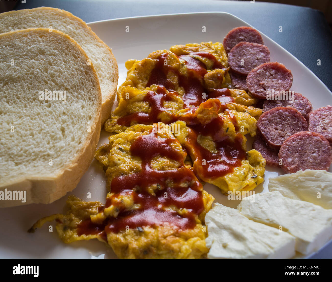 Scrambled Eggs With Ketchup With Bread Salami And Cheese Stock Photo Alamy