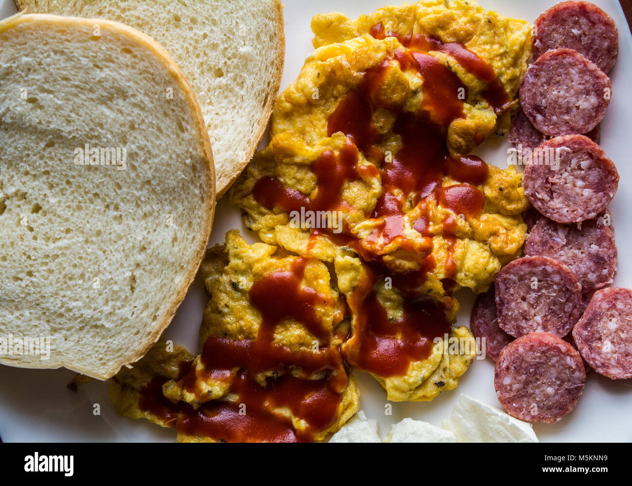 Scrambled Eggs With Ketchup With Bread Salami And Cheese Stock Photo Alamy