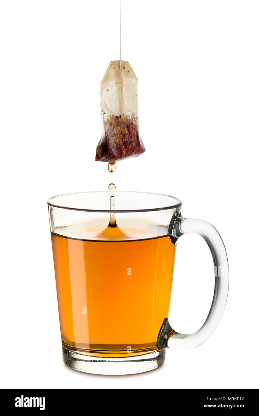 glass cup full of tea with tea-bag dropping, on white background Stock  Photo - Alamy