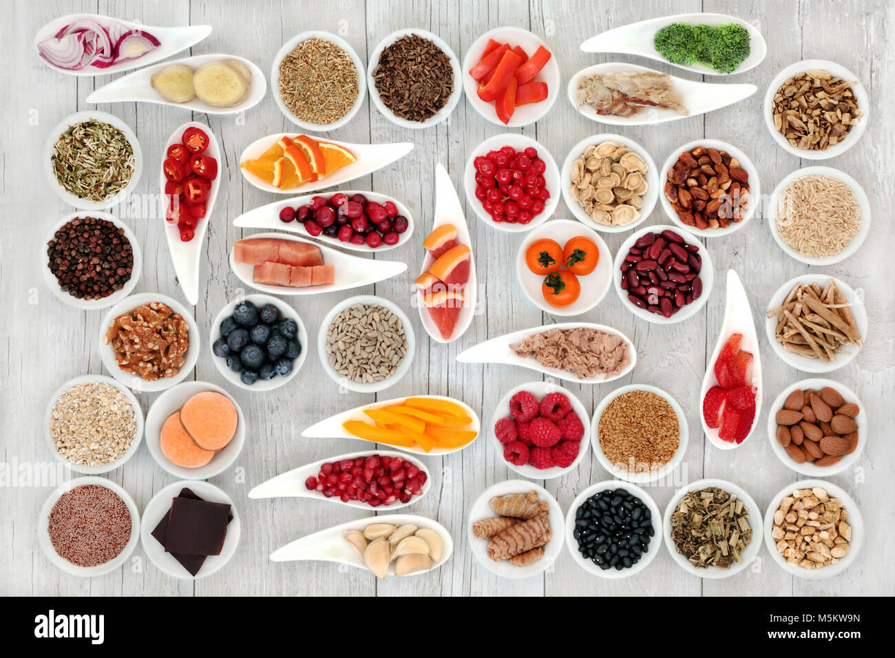 Health food for a healthy heart with fish, vegetables, fruit, nuts