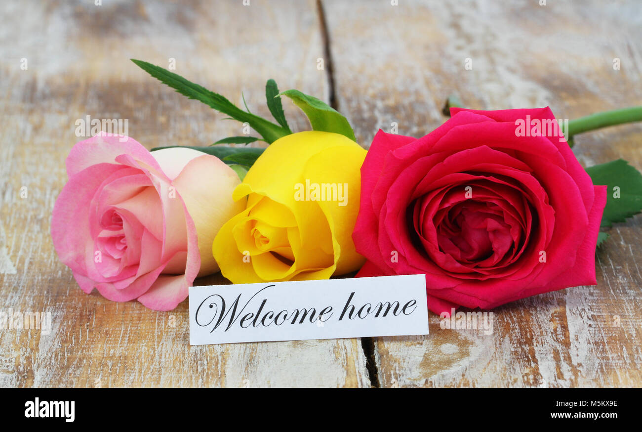 Welcome home card with three colorful roses on wooden surface Stock Photo -  Alamy