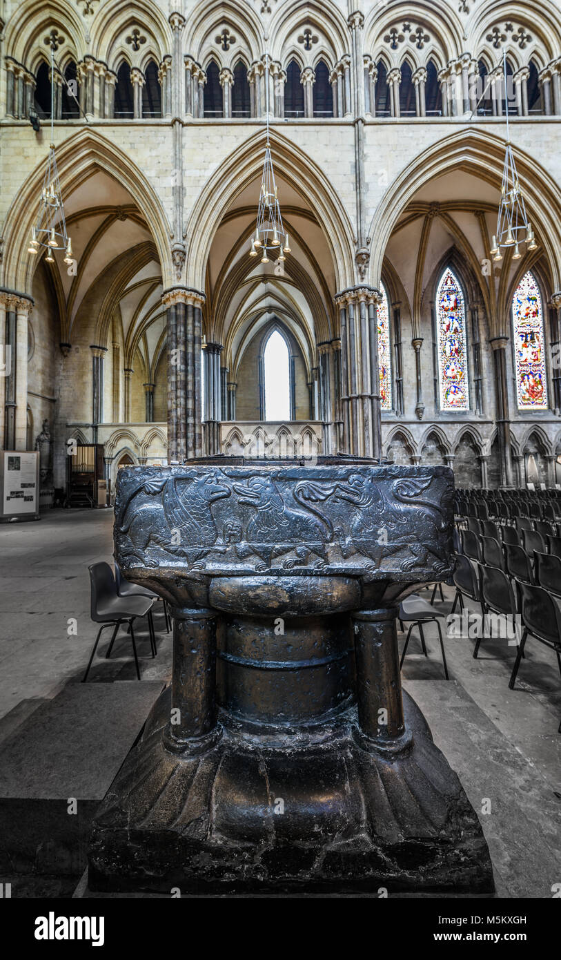 The baptism font at the medieval christian cathedral built by the normans at Lincoln, England. Stock Photo