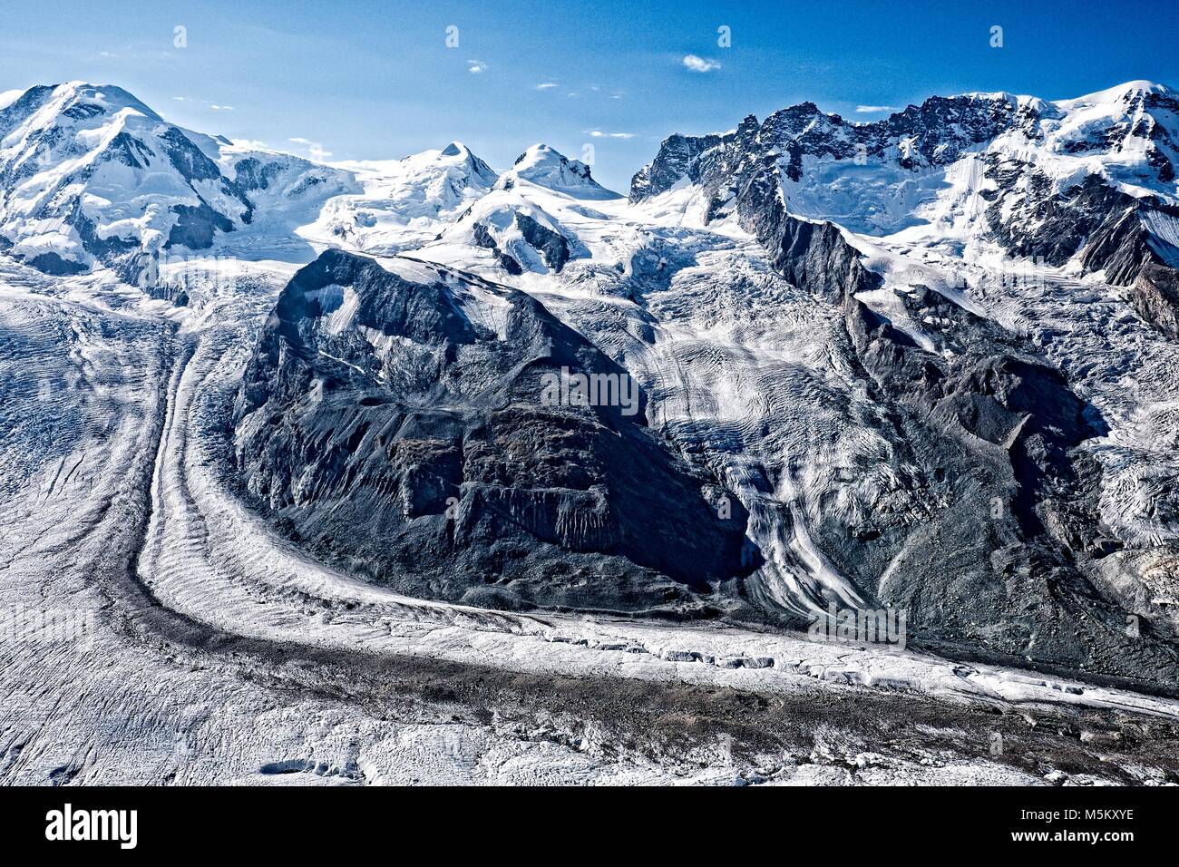 As ice descends into the Gornergletscher Valley it brings with it rocks that have been eroded and are now carried as moraine. Stock Photo